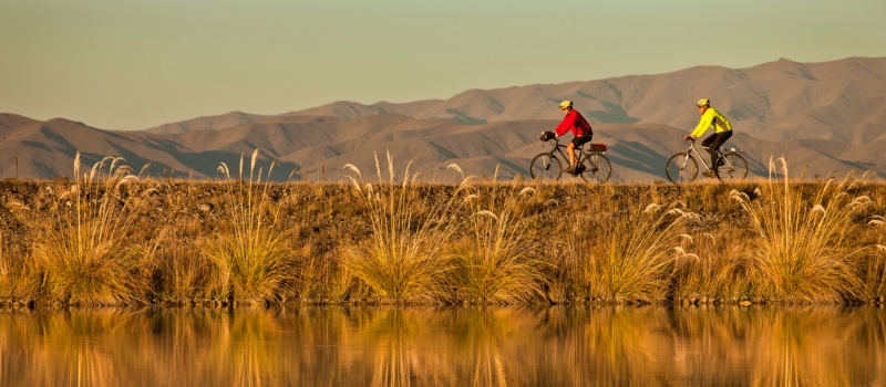 Clients riding along side the beautiful Tekapo canal system on one of our New Zealand cycle journeys |  <i>Colin Monteath</i>